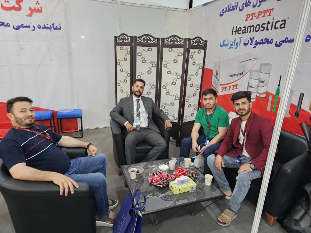 Afghan Circle Ltd. team in discussion with laboratory diagnostics partners at an exhibition.